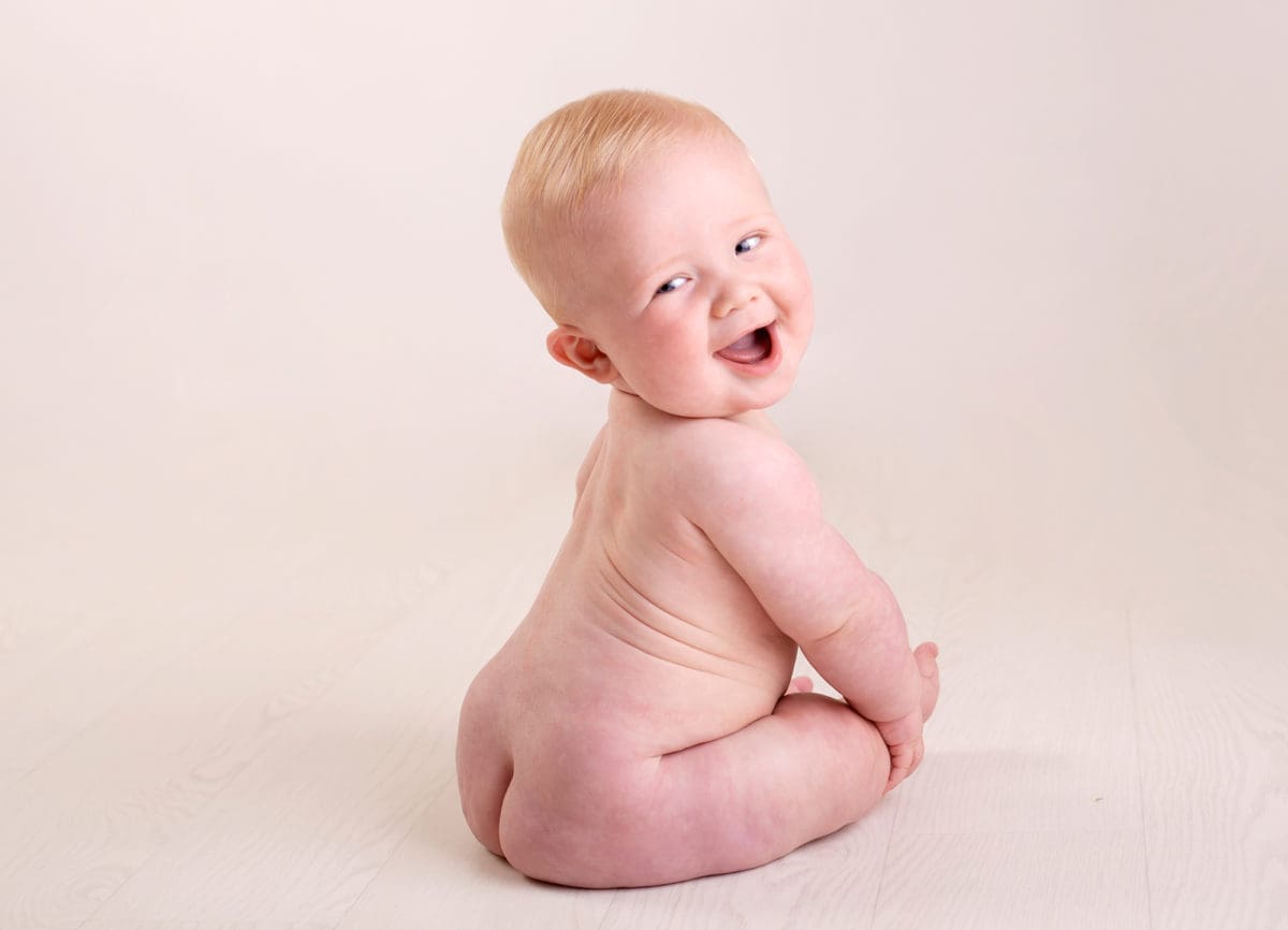 Colour baby photo portrait of cheeky baby in photography session