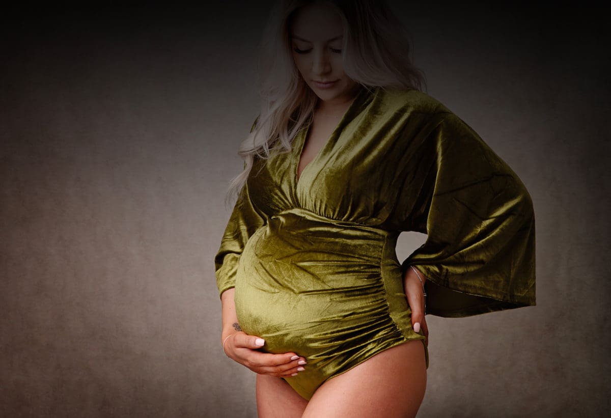 Pregnancy portrait with baby bump and maternity body suit