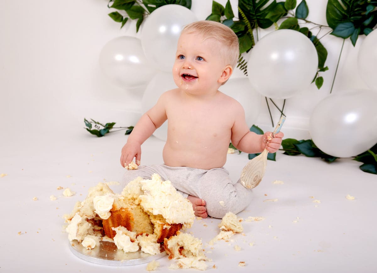 First birthday cake smash photoshoot baby boy with balloons and giant cup cake