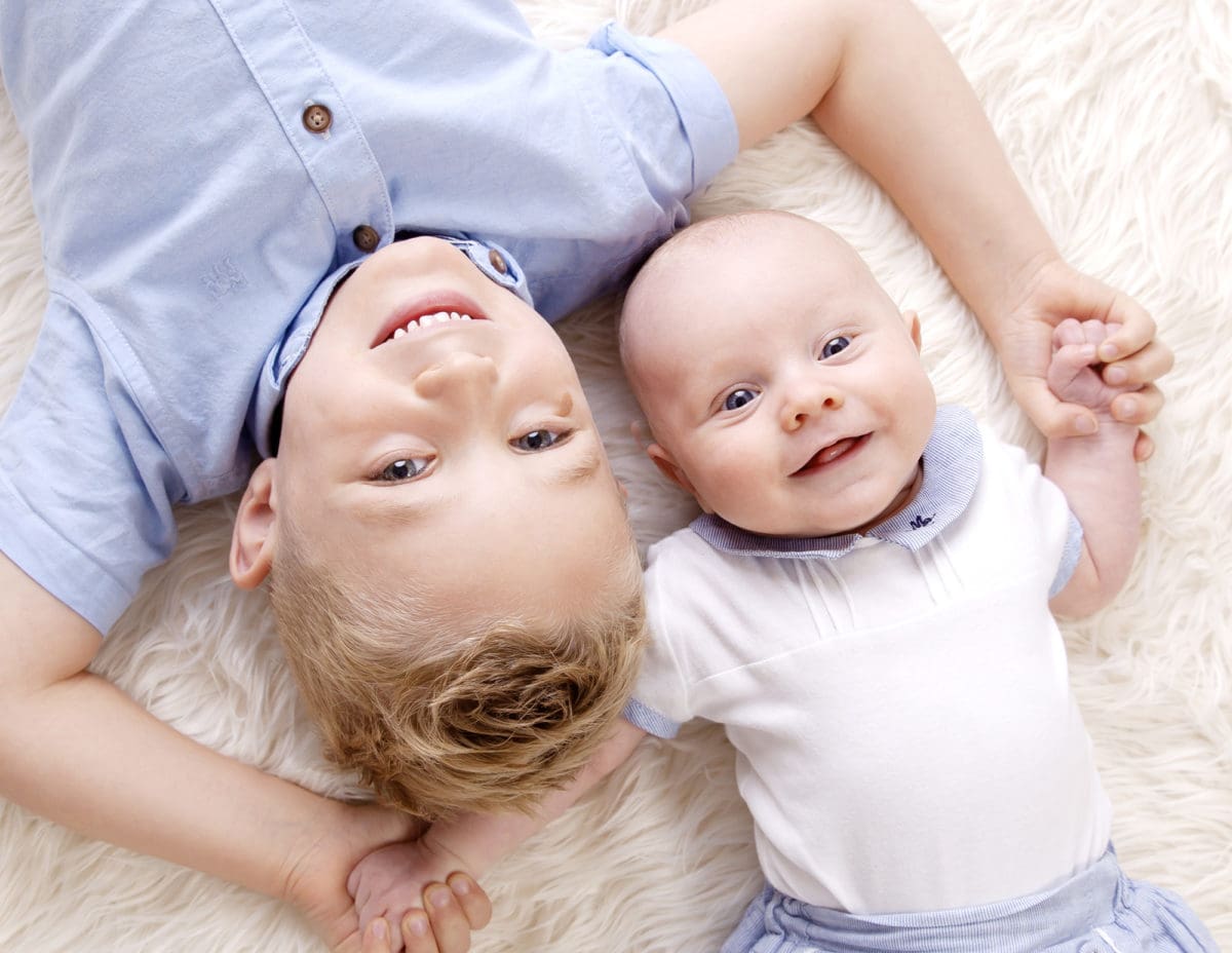 Young boy and baby in a children’s portrait photoshoot