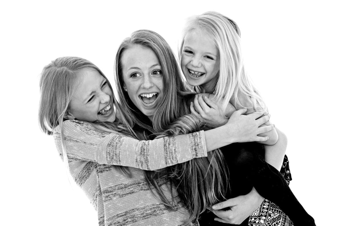 Monochrome image of three sisters enjoying a children’s portrait photography session