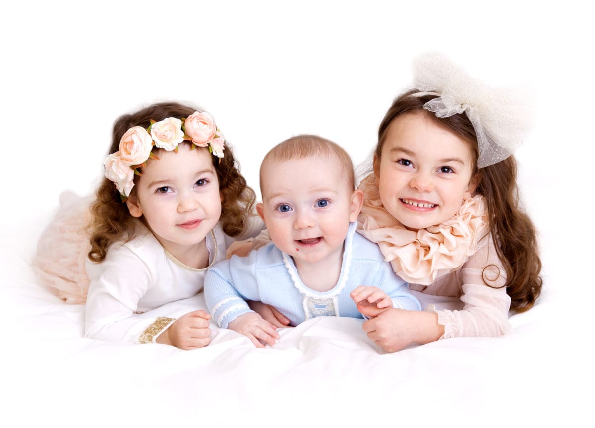 Siblings photographed together as part of a family portrait session