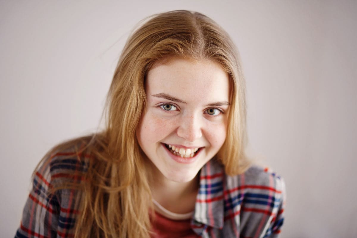 Photographic portrait of smiling teenage girl